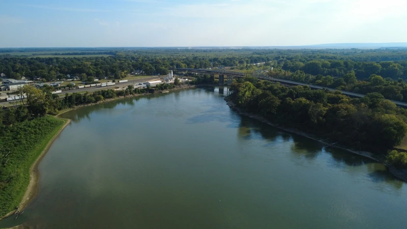 A wider river view looking toward the bridge